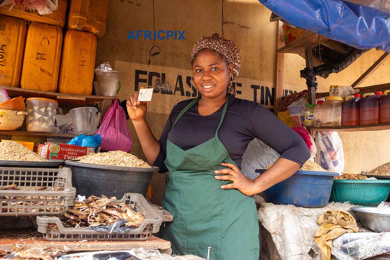 Happy Market Woman Holding ATM card debt card